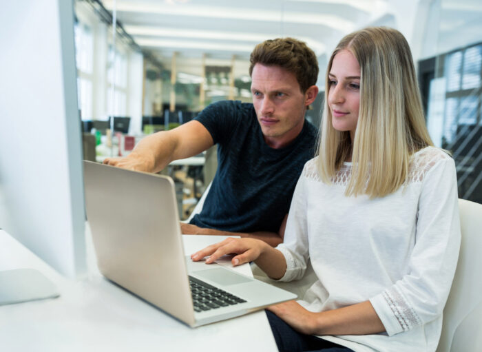 Male and female graphic designers interacting with each other Male and female graphic designers interacting with each other in office