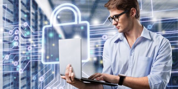 young it engeneer business man with thin modern aluminium laptop in network server room